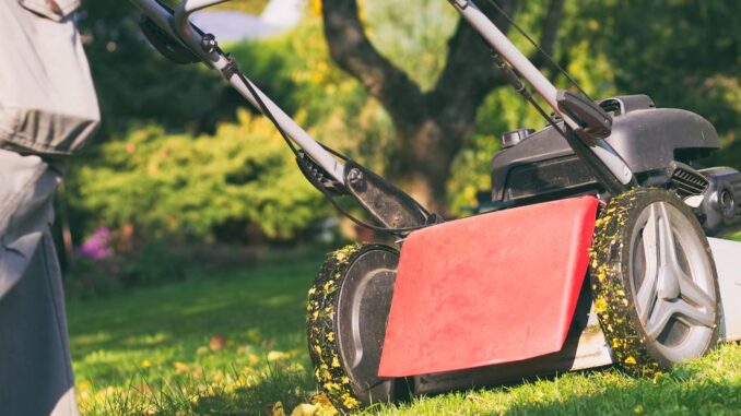 mowing-the-grass-with-a-lawn-mower-in-early-autumn-royalty-free-image-1752180309.pjpeg
